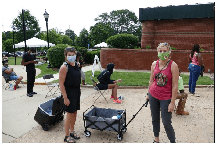 This image has an empty alt attribute; its file name is handing-out-water-in-ga.png